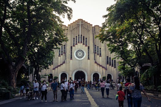 Crowd in front of St. Andrew's Cathedral, Parañaque, NCR, Philippines, during daytime.