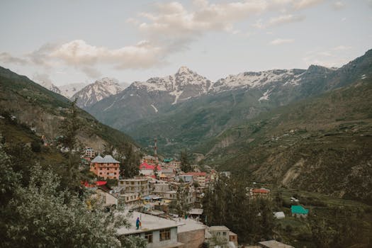 Picturesque village nestled in the Himalayan mountains of Manali, India, during a calm day.