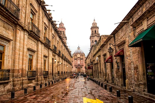 Historic cobblestone street leading to Morelia Cathedral, rich in architecture and culture.