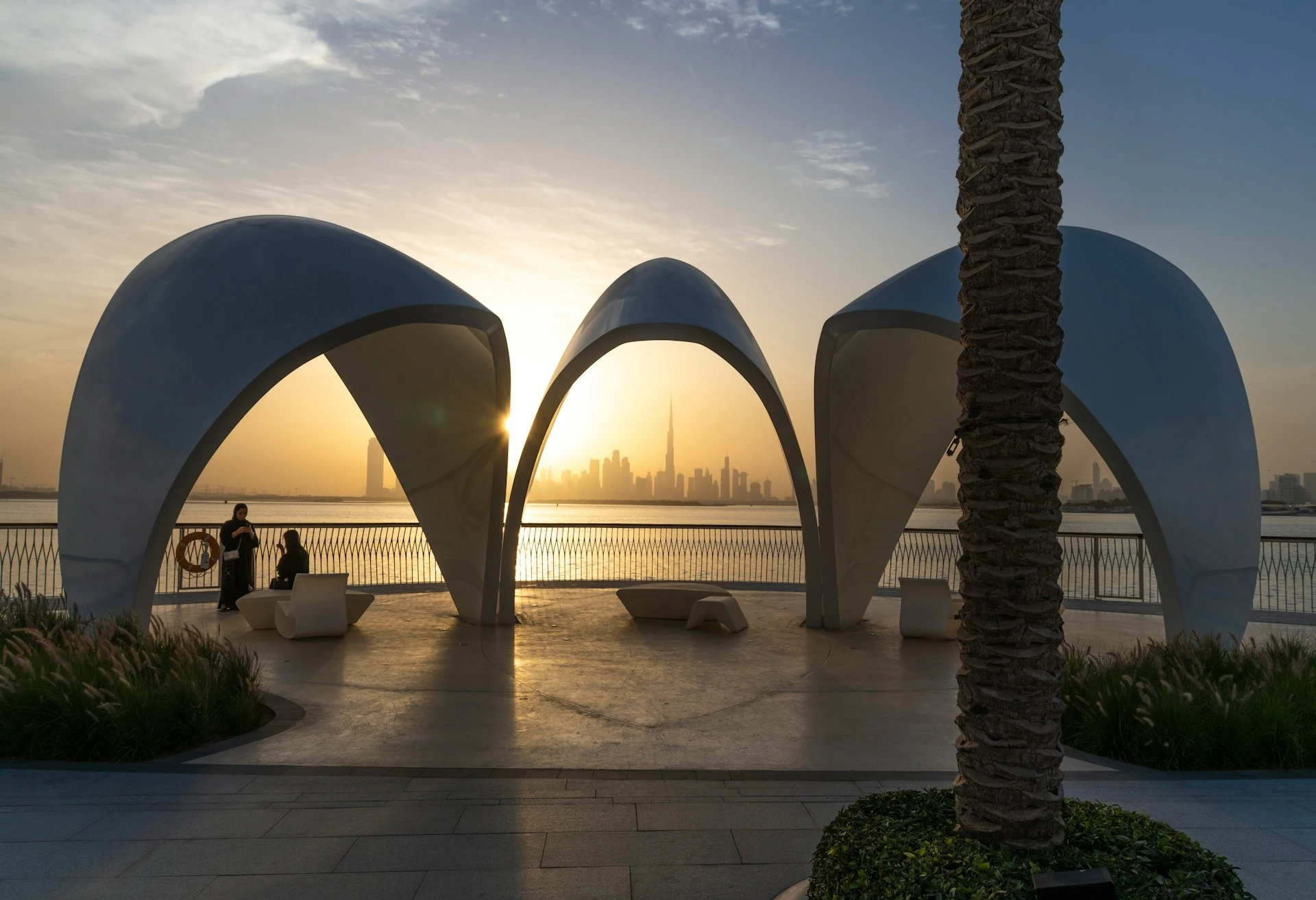 Sunrise over Dubai skyline with golden light reflecting off the city towers, a breathtaking view tourists search for across the UAE