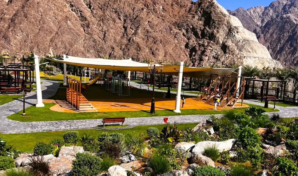 Shees Park in Sharjah: Waterfall, Timings, Things to Do and Nearby Hotels 2 Children's play area with shade sails and rock gardens at Shees Park in Sharjah