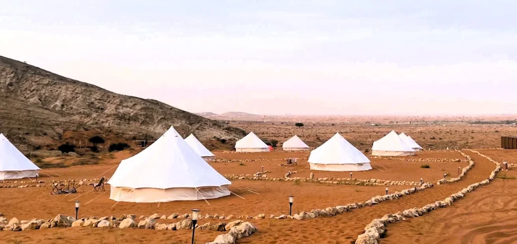 Mleiha Glamping in Sharjah: Tents, Season, Activities and Tips 4 Mleiha glamping bell tents along sandy paths in the Sharjah desert